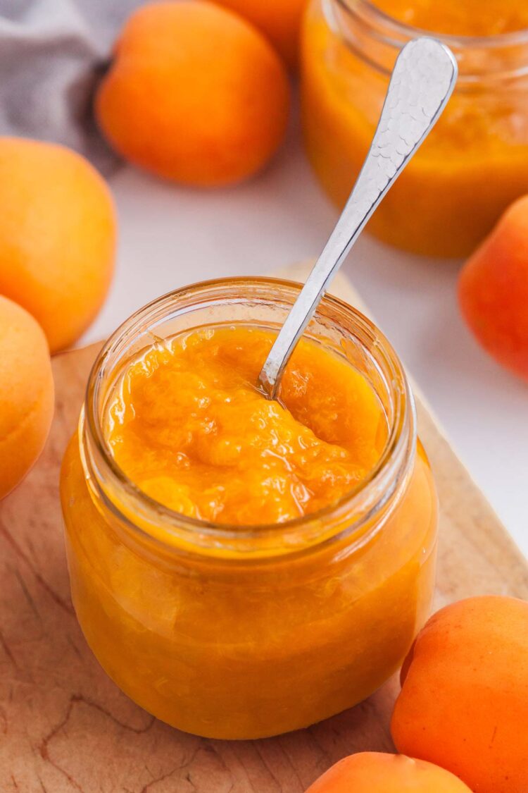 spoon in a jar of apricot preserves