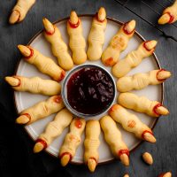 plate filled with witch finger cookies and jam