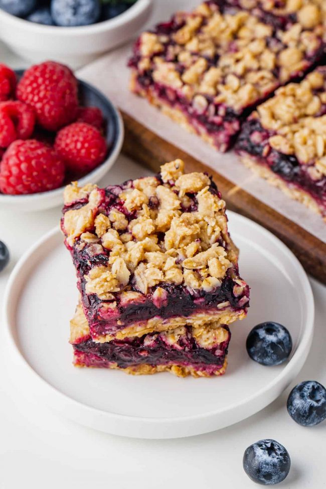 These berry bars have a thick layer of blueberries mixed with berry jam nestled between a crumb-like crust and topping! Can be made with all-purpose, gluten-free or whole wheat flour. Can also be made vegan and dairy-free.