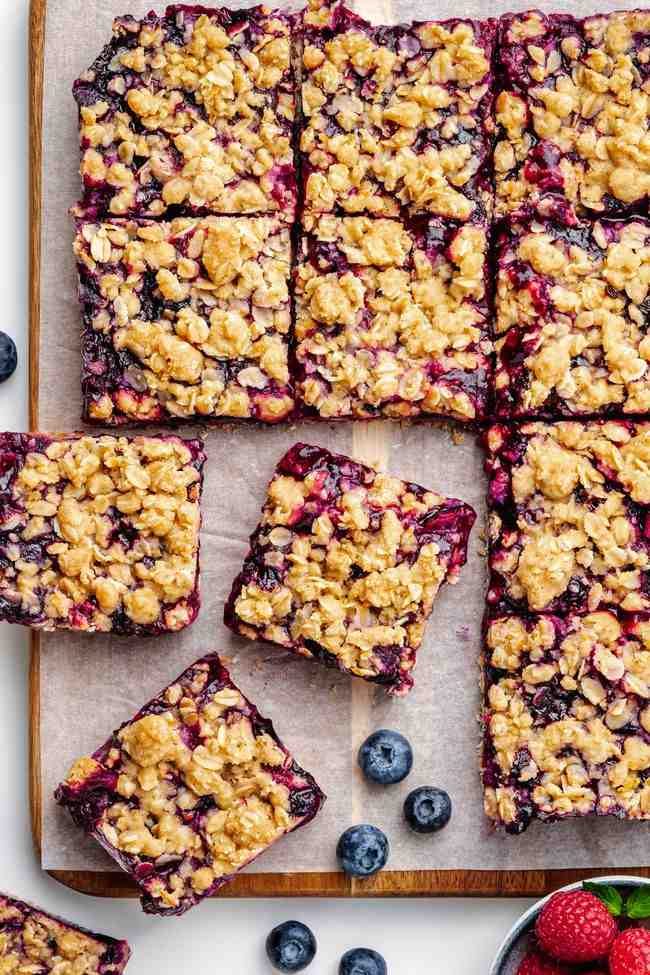 These berry bars have a thick layer of blueberries mixed with berry jam nestled between a crumb-like crust and topping! Can be made with all-purpose, gluten-free or whole wheat flour. Can also be made vegan and dairy-free.