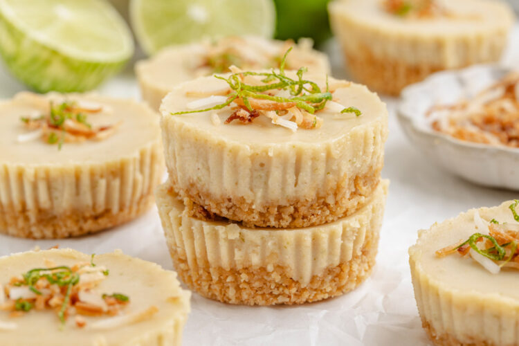 2 paleo key lime pies stacked on top of each other on a white table