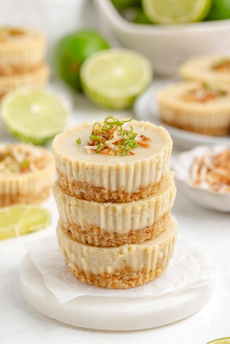 3 paleo key lime pies stacked on top of each other on a white table