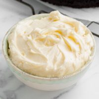 Image of a bowl of healthier cream cheese frosting that uses a fraction of the sugar in traditional recipes and tastes really similar to cheesecake batter!