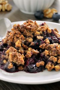 white plate filled with paleo blueberry crisp