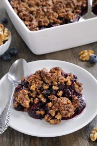 paleo blueberry crisp on a white plate