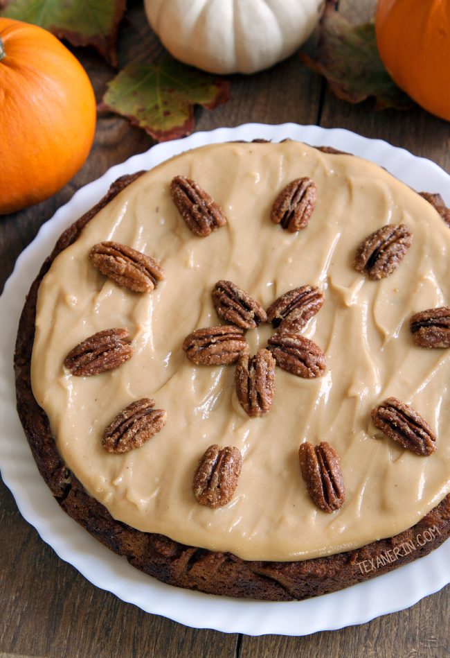 This paleo pumpkin cake is super moist and easy to make! Topped off with maple cream frosting and maple candied pecans.