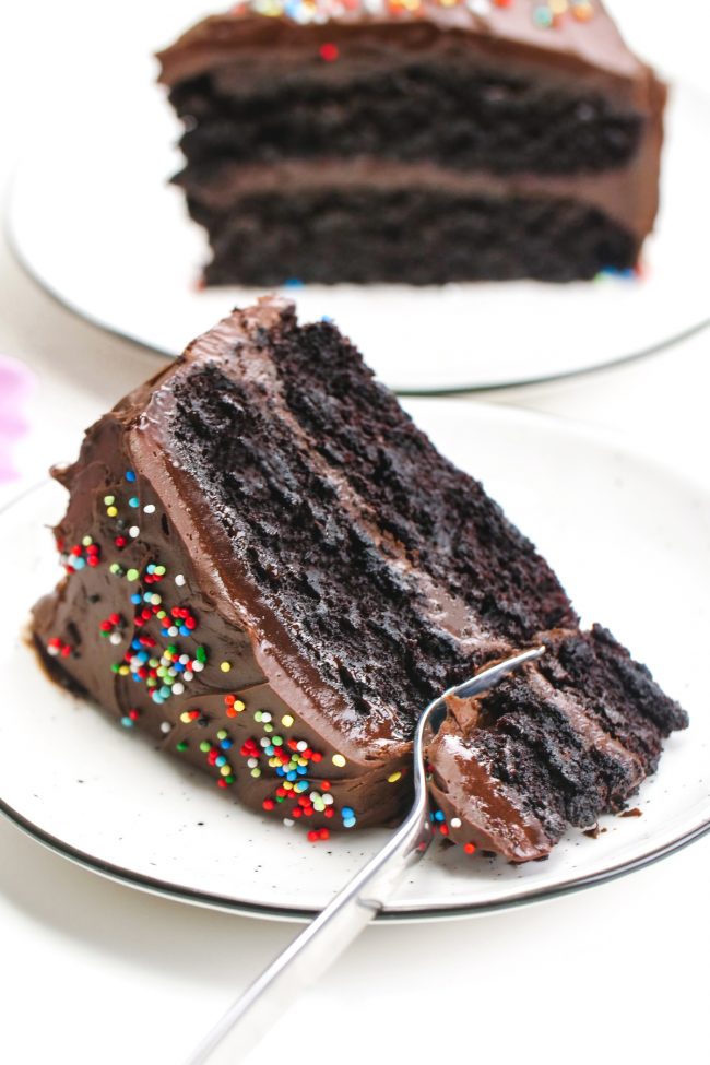 This vegan chocolate cake is fudgy, super moist, chocolaty and is topped off with an easy whipped chocolate ganache frosting! Can be made gluten-free, whole wheat or with all-purpose flour. Really tastes just like a regular chocolate cake!