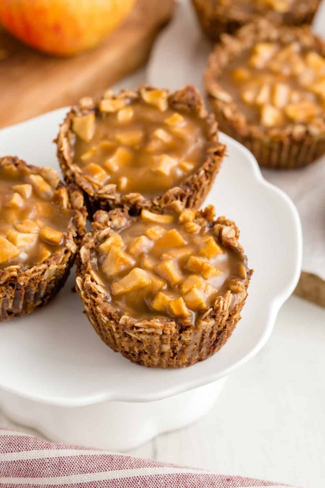 These mini apple pies have a delicious oatmeal cookie crust and are covered in caramel sauce. The perfect individual dessert for Thanksgiving! Gluten-free, vegan and dairy-free.