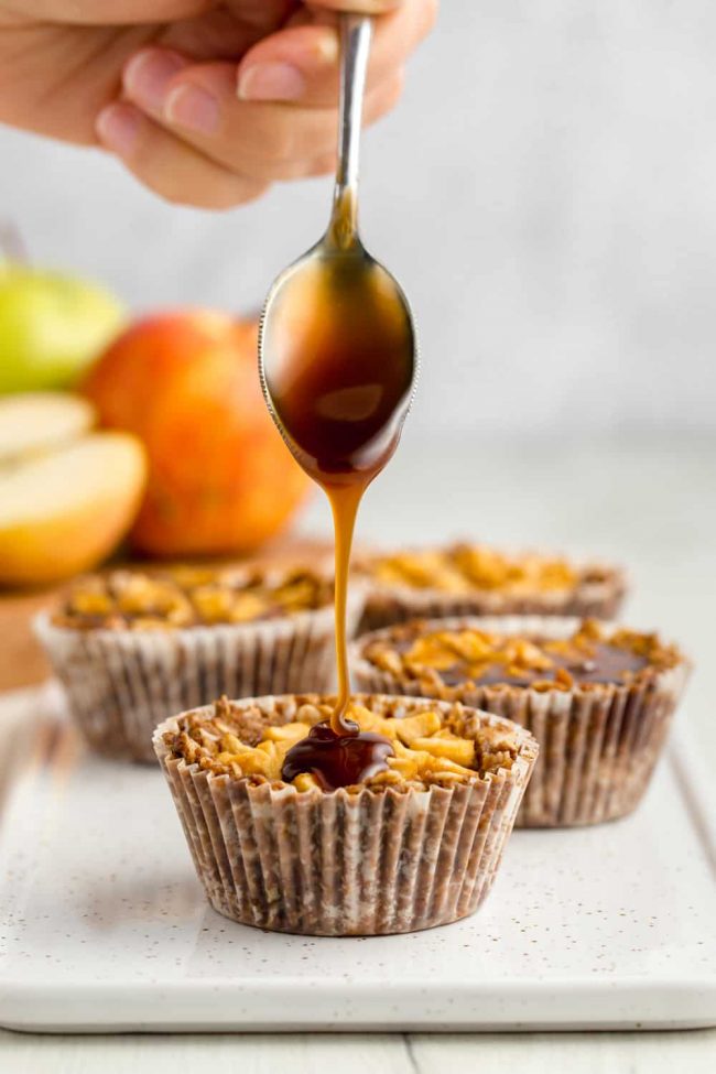 These delicious mini apple pies have an oatmeal cookie crust and are covered in caramel sauce. The perfect individual dessert for Thanksgiving! Gluten-free, vegan and dairy-free.