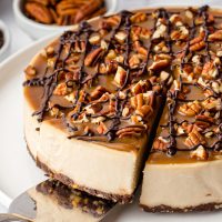 This paleo vegan turtle cheesecake is rich, creamy and won't leave you missing the dairy! It's also no-bake and perfect for Christmas.