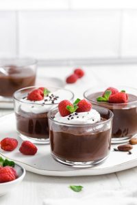 chocolate chia pudding in jars on white table