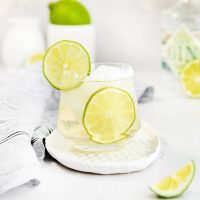 glass of gin margarita with limes