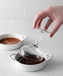 dipping cocktail glass into ground coffee and sugar