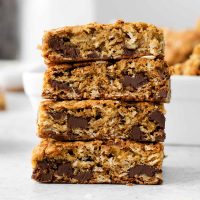 stack of chocolate chip oatmeal bars on a white table
