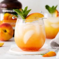 wine glass filled with a Georgia peach cocktail
