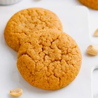 photo showing two keto peanut butter cookies one stacked against the other and ready to eat