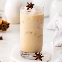 anise star on top of glass of iced chai latte (a starbucks copycat)