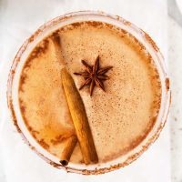 cinnamon stick and anise star on top of a pumpkin margarita