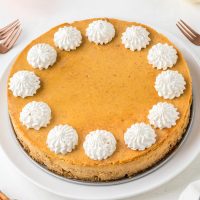gluten-free pumpkin cheesecake with whipped cream on top
