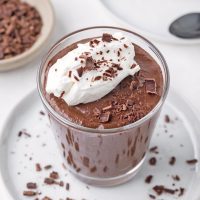 top view image showing protein pudding with a dab of whipped cream and chocolate shavings