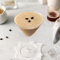 photo a martini glass full of tequila espresso martini garnished with three roasted espresso beans