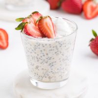 image showing overnight oats with water topped with fresh, sliced strawberries