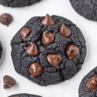 close up image of black cookies with chocolate chips on top