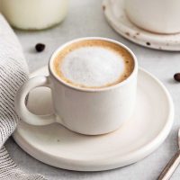Photo of an espresso macchiato with a perfect amount of foamed milk on top of the espresso.
