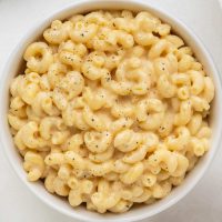 Close-up photo of a bowl full of creamy protein mac and cheese.