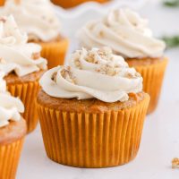 eggfree carrot cupcake with cream cheese frosting on top