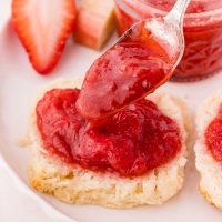 spooning jam onto a biscuit