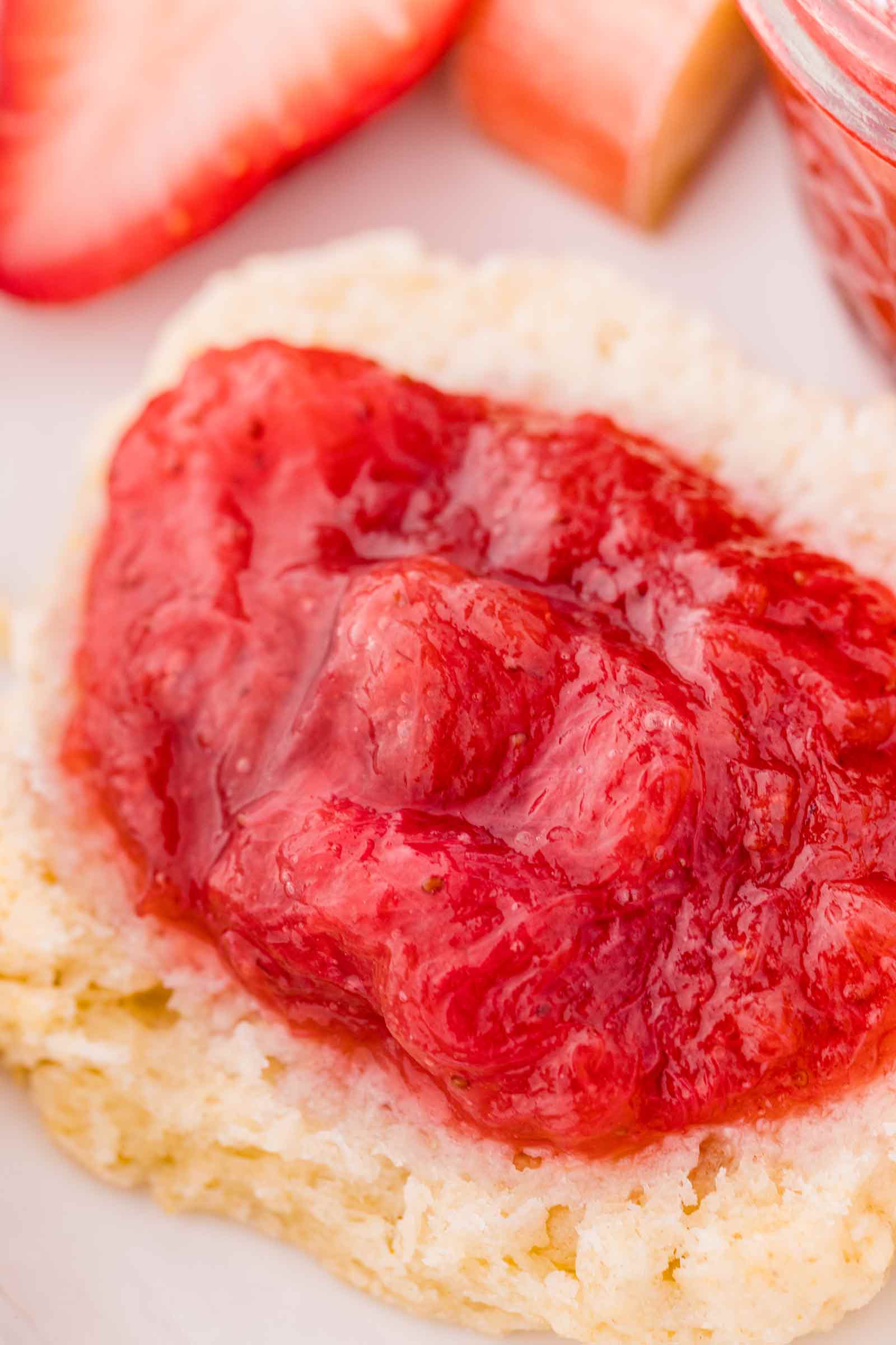 close-up of strawberry rhubarb preserves on a biscuit