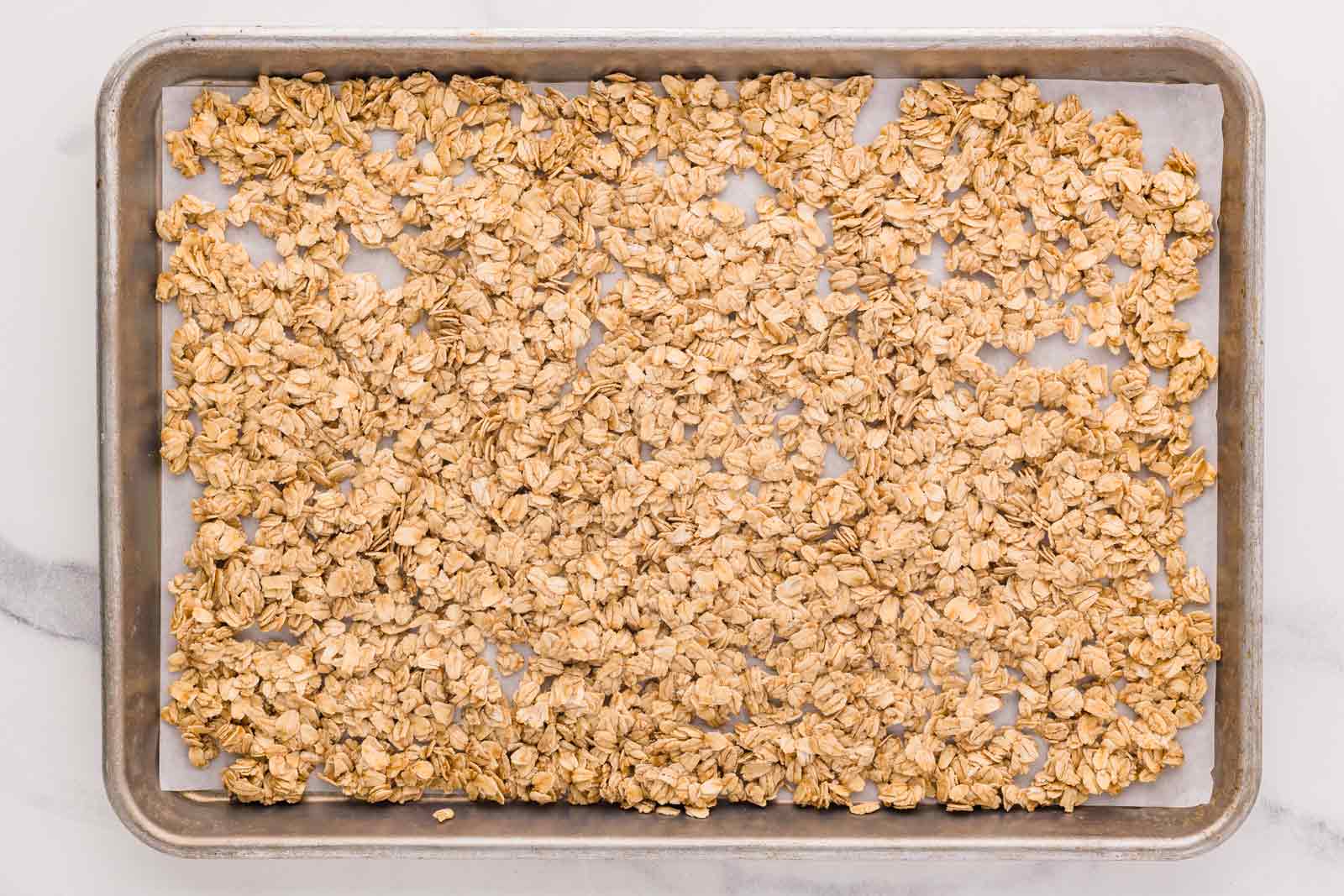 unbaked granola on cookie sheet