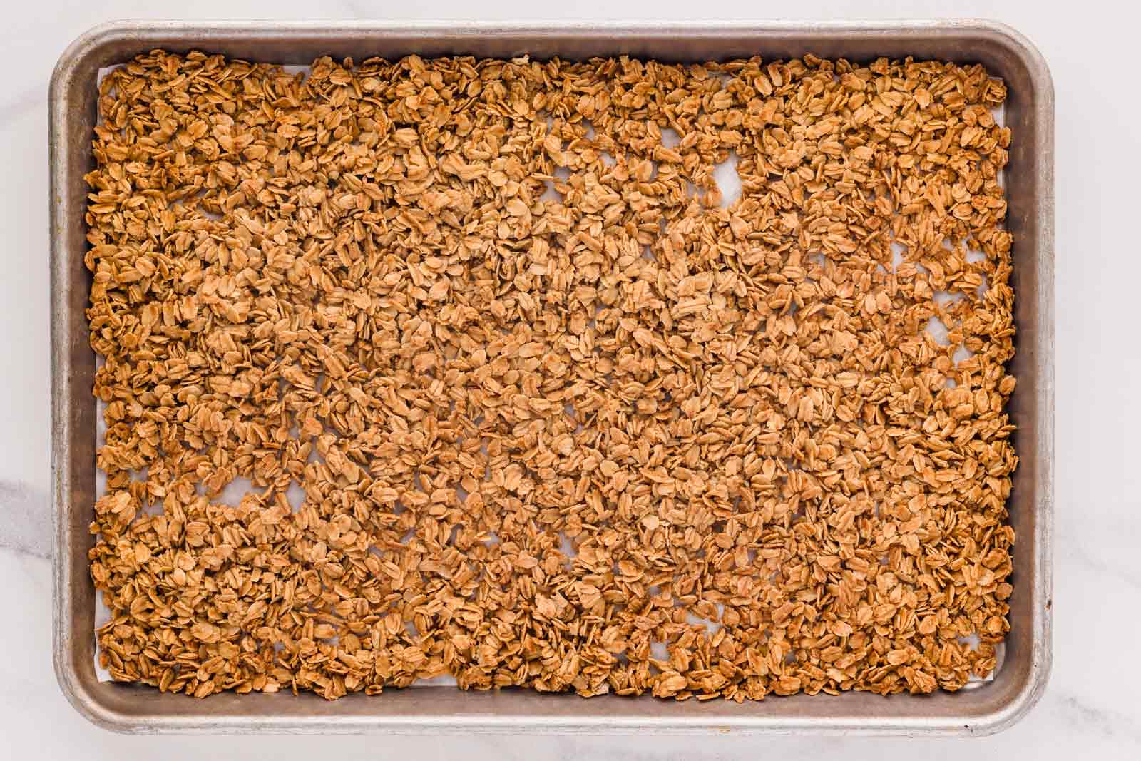 baked granola on cookie sheet