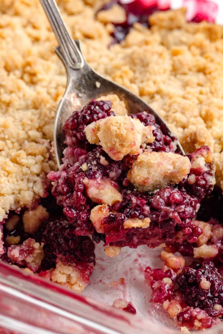 spoon digging into the baked blackberry crumble