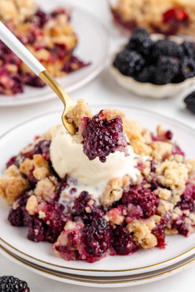 a fork digging into some blackberry crumble