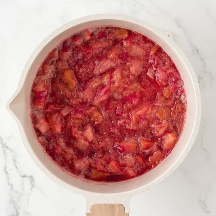 finished rhubarb compote in a white pot on a white table