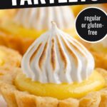 pin image for lemon meringue tartlets showing a tartlet on a wooden cutting board and a text saying regular or gluten-free