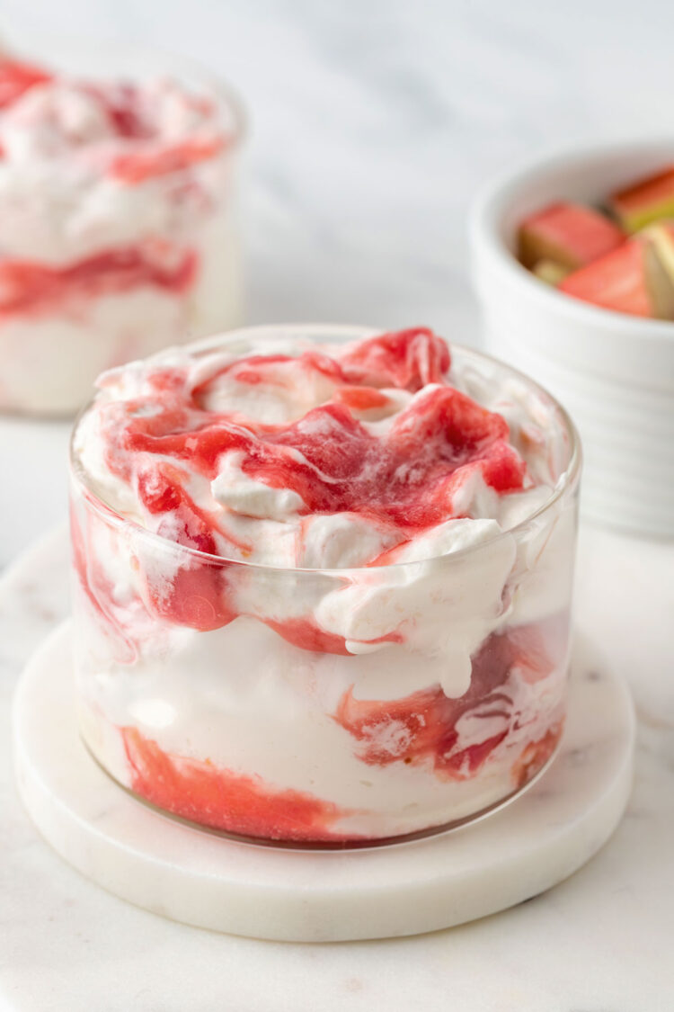 close-up of rhubarb fool on a white table with another fool in the background