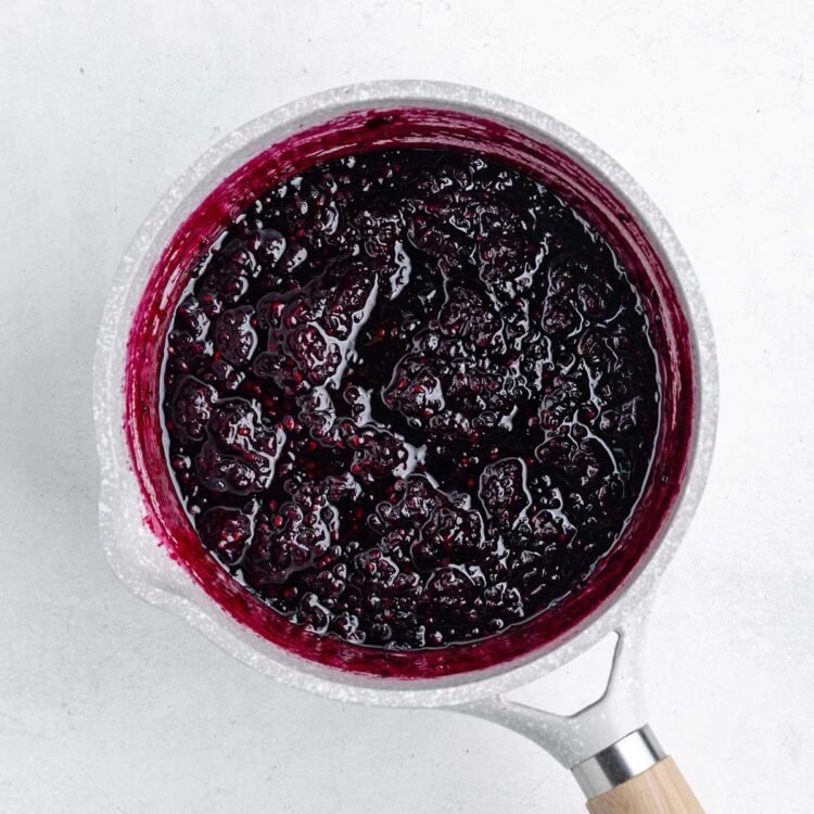 saucepan with cooked blackberry jam in it