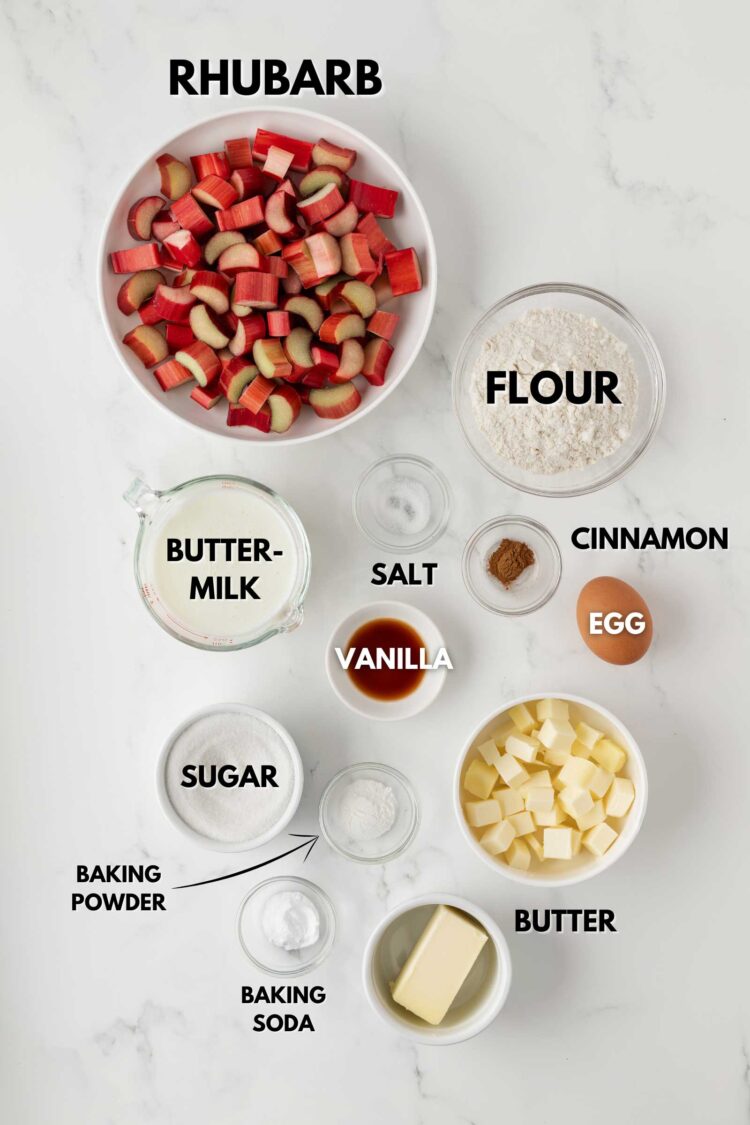ingredients laid out to make rhubarb cake on a marble table