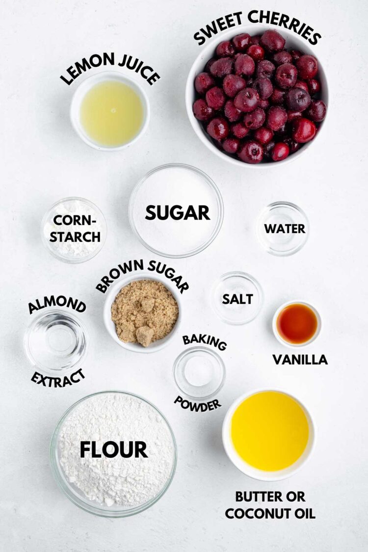 ingredients laid out on white table needed to make a cherry tart