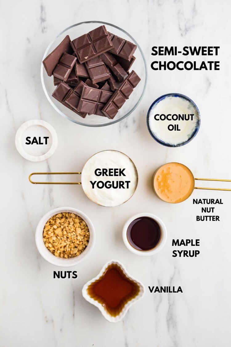 all ingredients needed to make greek yogurt ice cream bars laid out on a marble table
