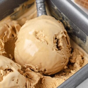 ice cream scoop scooping a scoop of butterscotch ice cream