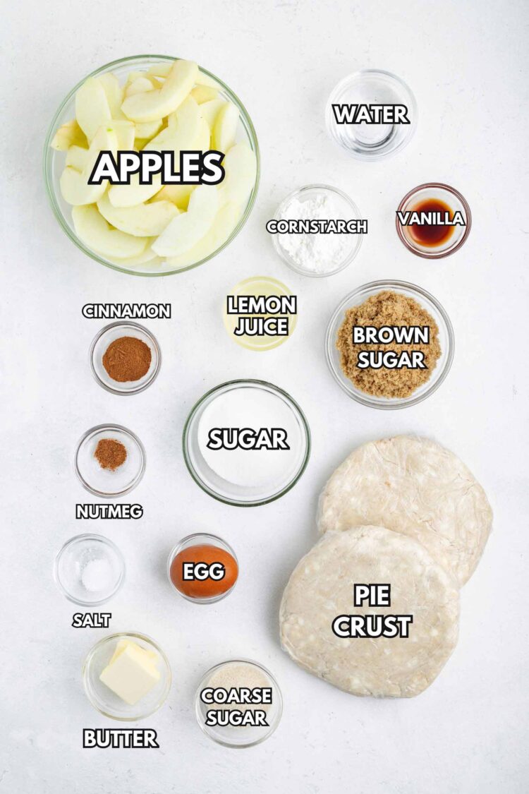 Ingredients for gluten-free apple pie, including apples, spices, sugars, and pie crust, arranged in clear containers.