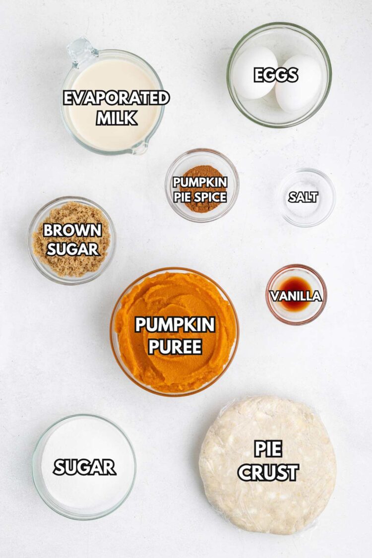 Ingredients for gluten-free pumpkin pie, including pumpkin puree, eggs, evaporated milk, and spices, arranged in bowls.